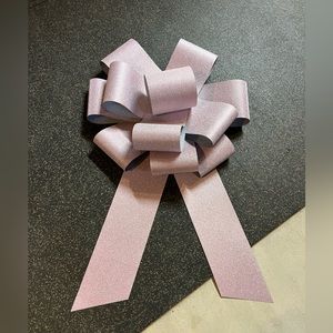 Extra large, pink bow, the type you would put on a new car gift